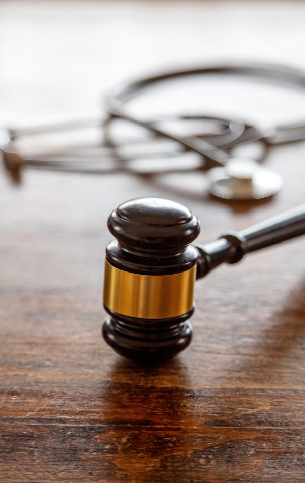 Healthcare Law. Medical stethoscope and judge gavel on lawyer office desk